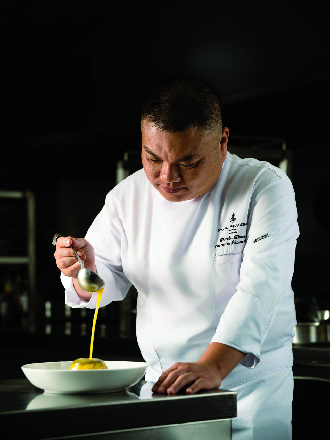 Zhang putting finishing touches on steamed duck with fish maw, bamboo shoots, and chestnut broth