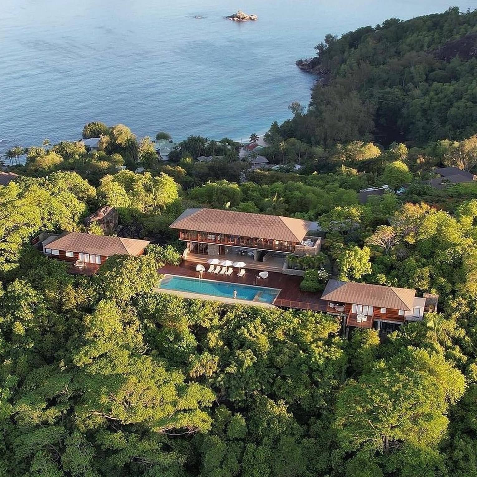 Aerial view of a private Seychelles hilltop villa, with a large patio and pool