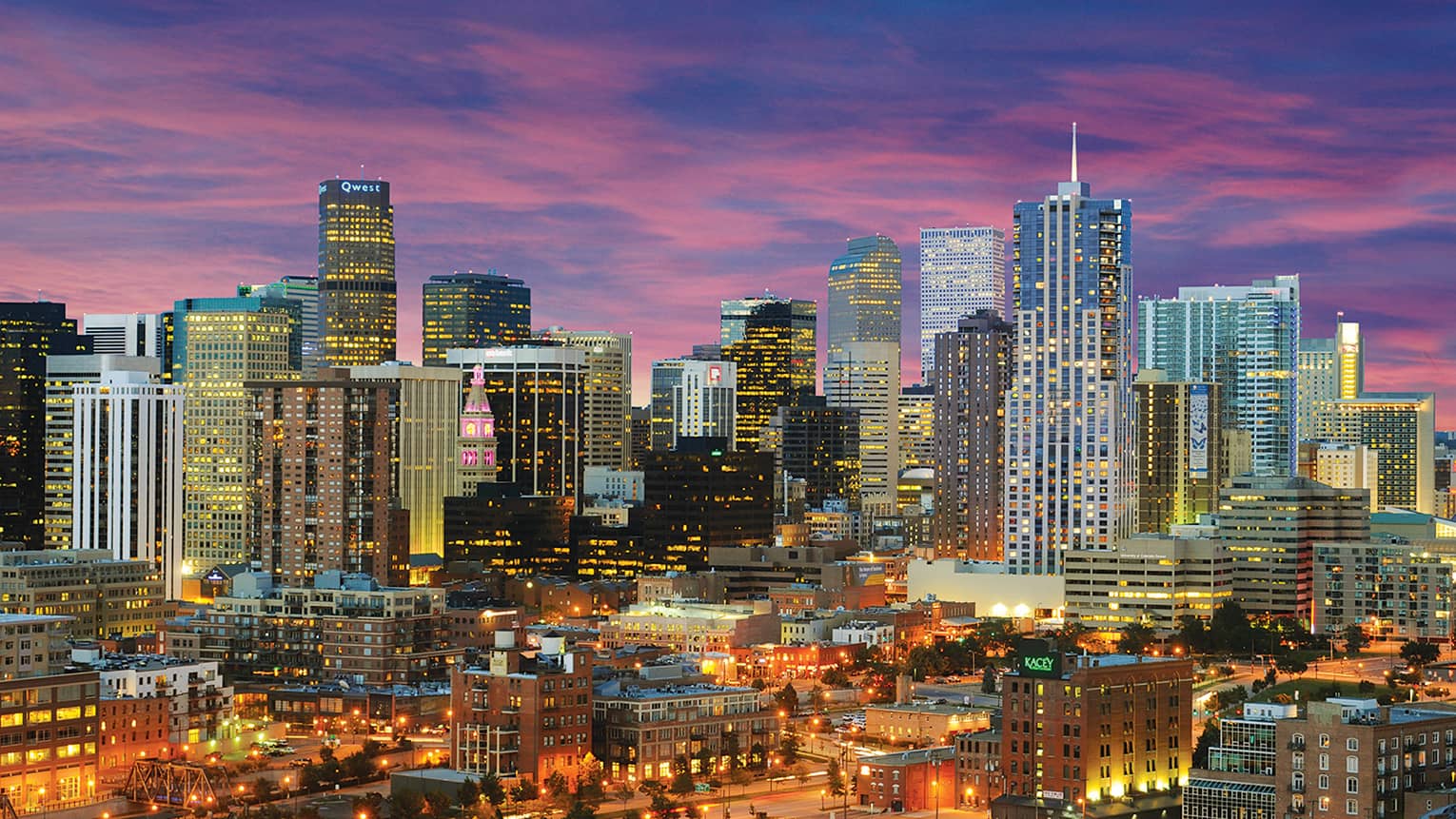 Aerial view of Denver skyline skyscrapers, highways, city lights at night