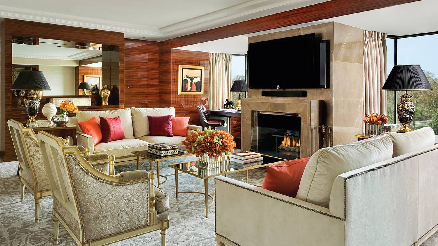 Presidential Suite elegant white sofas, armchairs by marble fireplace, desk, windows