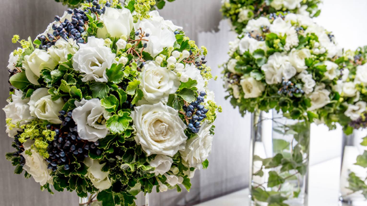 White roses floral arrangement in glass vases