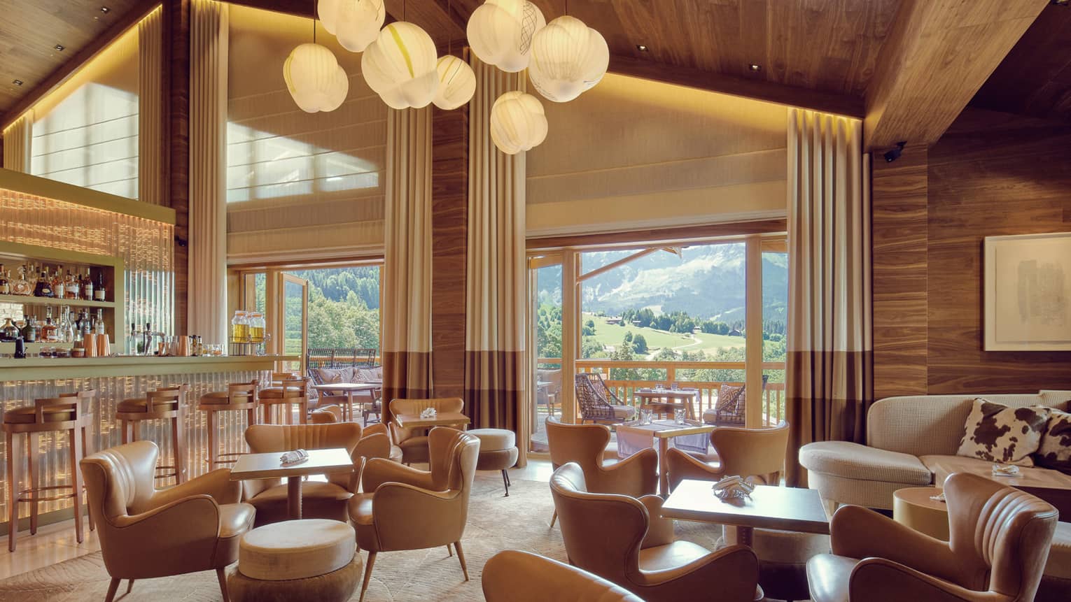 Lamps over retro-style cocktail tables, chairs in Bar Edmond lounge
