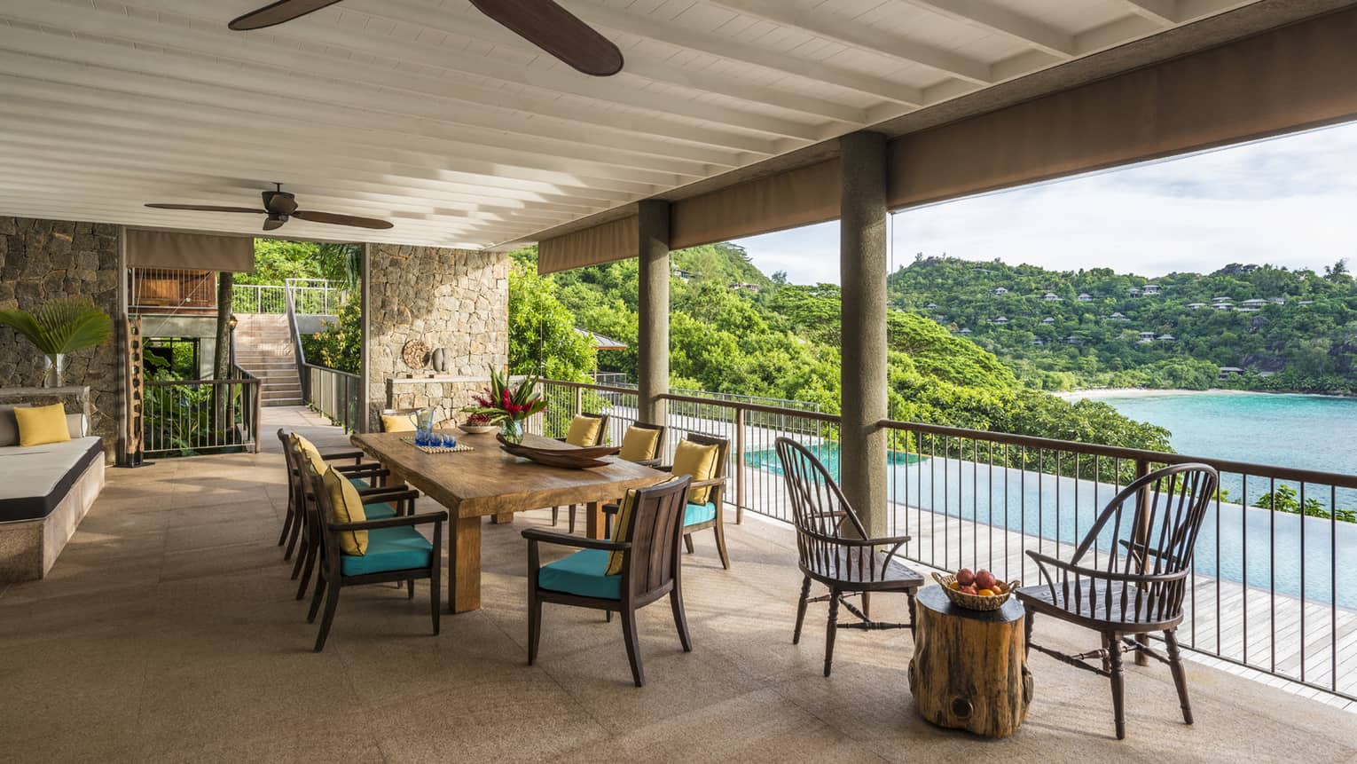 Four-Bedroom Residence Villa patio dining table, chairs under roof beside swimming pool