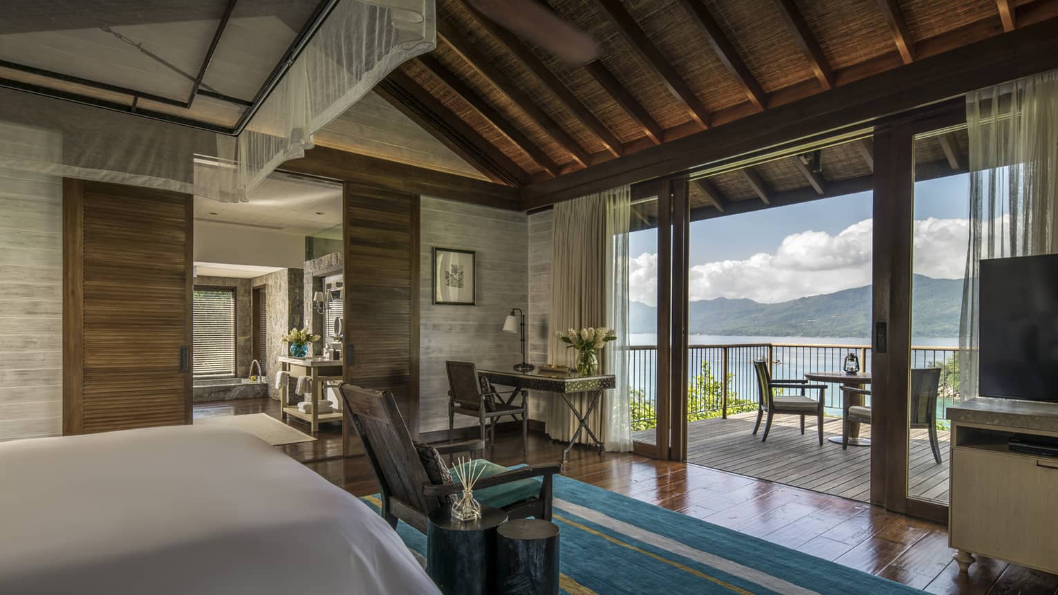 Three-Bedroom Residence Villa bedroom end of bed, blue carpet in front of patio door