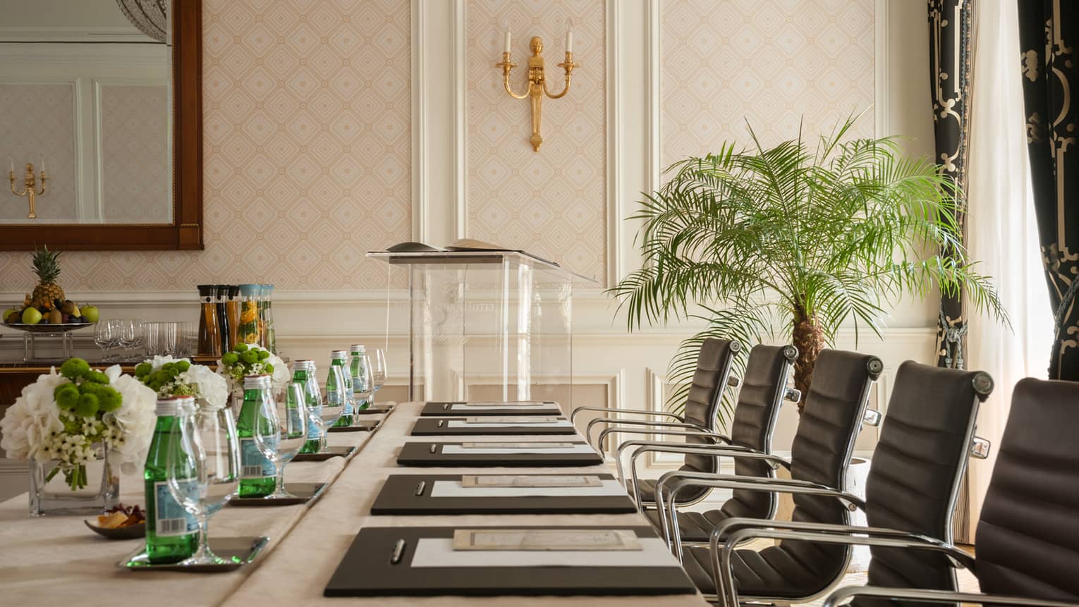 Phipps Room elegant boardroom meeting table lined with black executive chairs