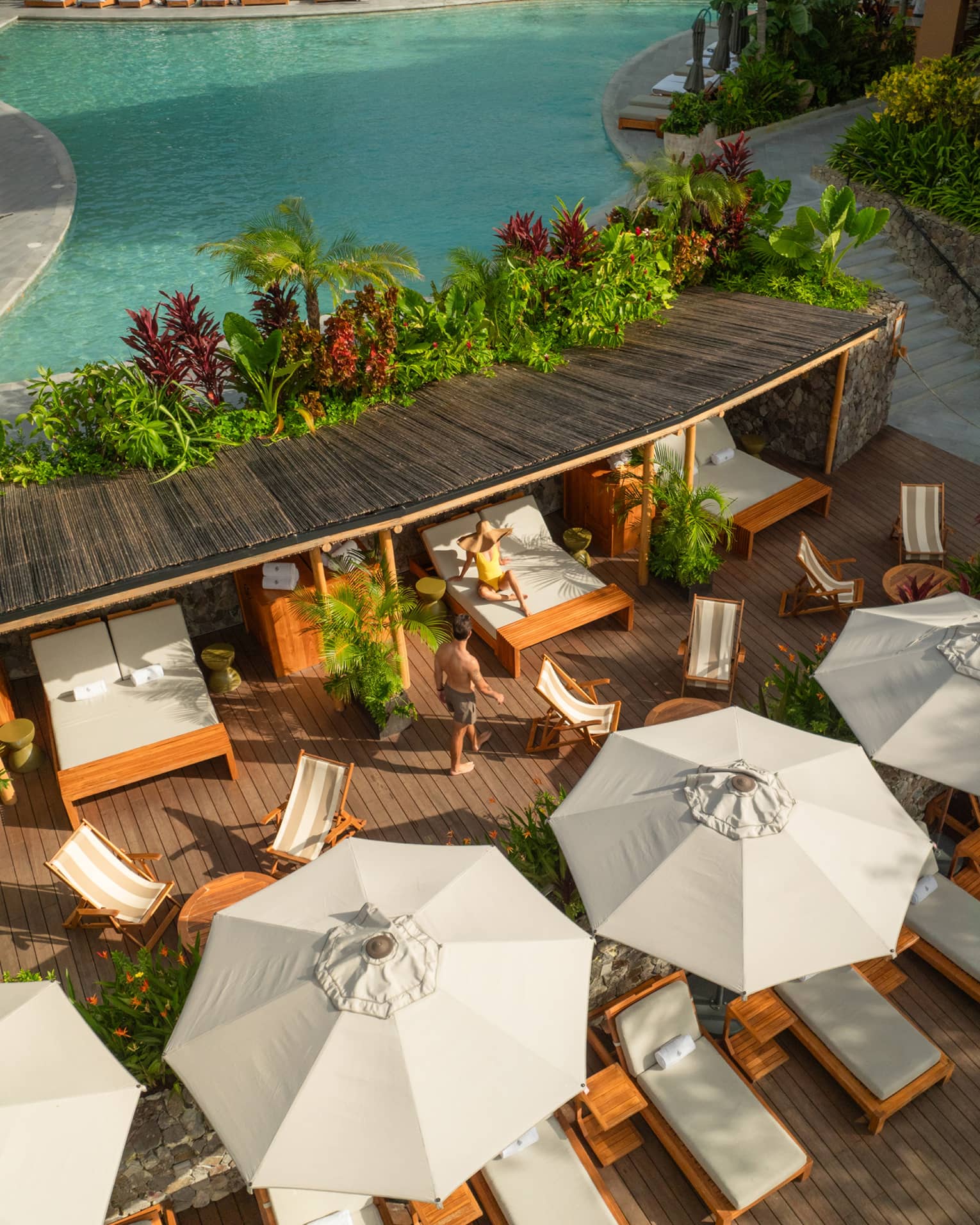 Aerial view of poolside cabanas and daybeds