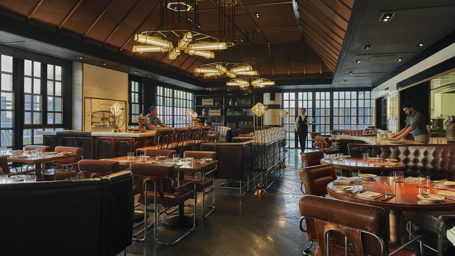 Restaurant and bar with brown leather seats and sofas, bar stools and contemporary lights