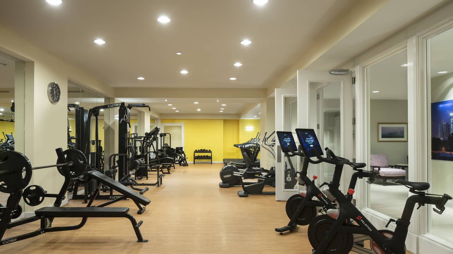 Fitness center room with weight lifting machines and bicycles.