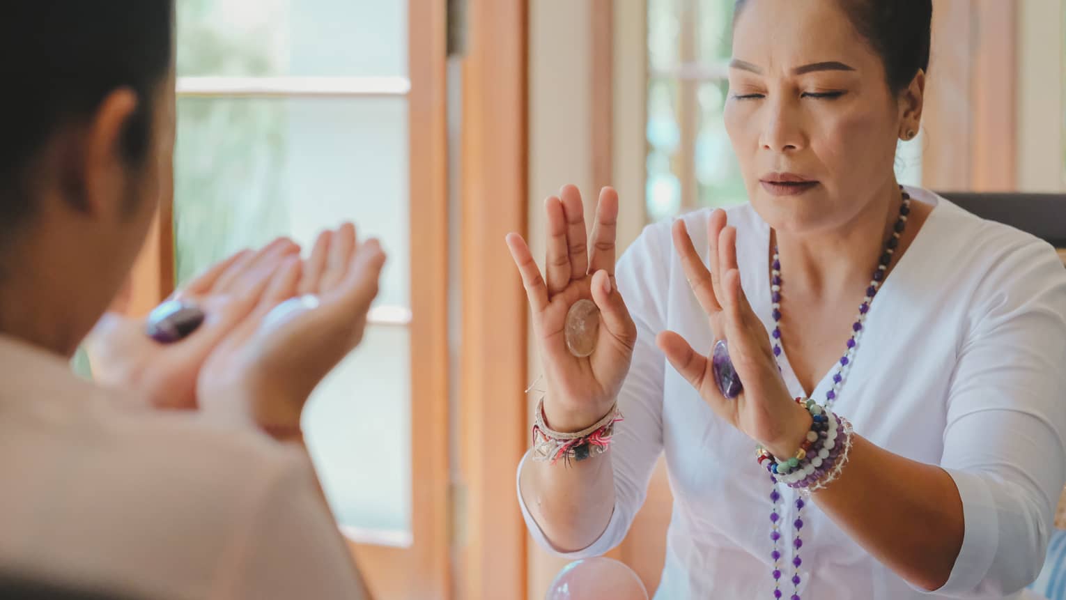 Healing Arts practitioner Ibu Jero conducts a crystal session