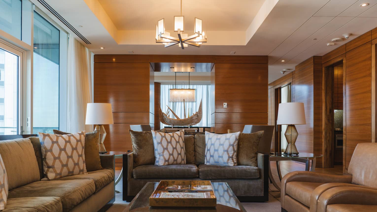Presidential Suite living room with three sofas and wood-panelled walls, at Four Seasons Hotel Baltimore