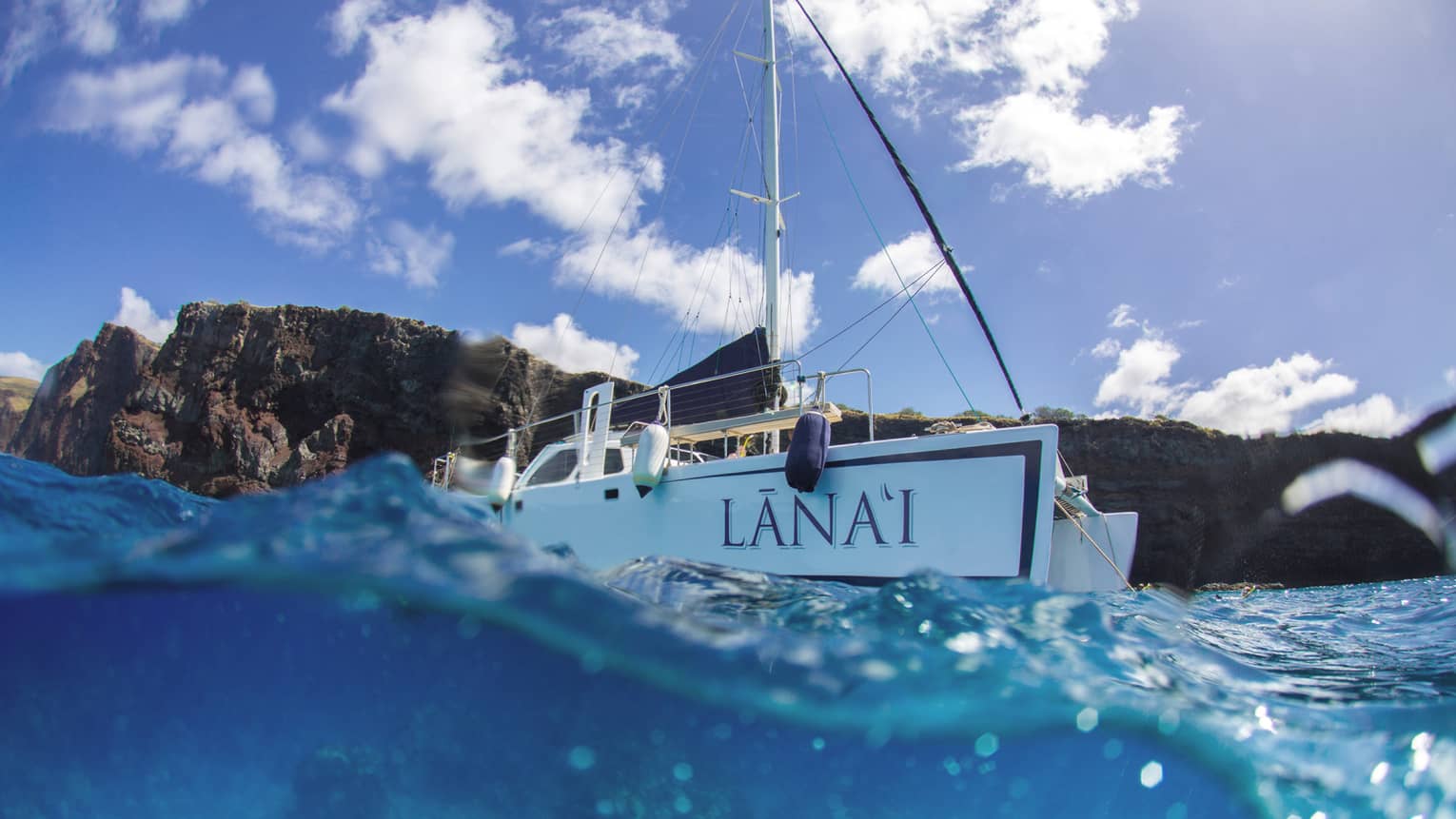 Lanai catamaran on blue waters headed out to sea