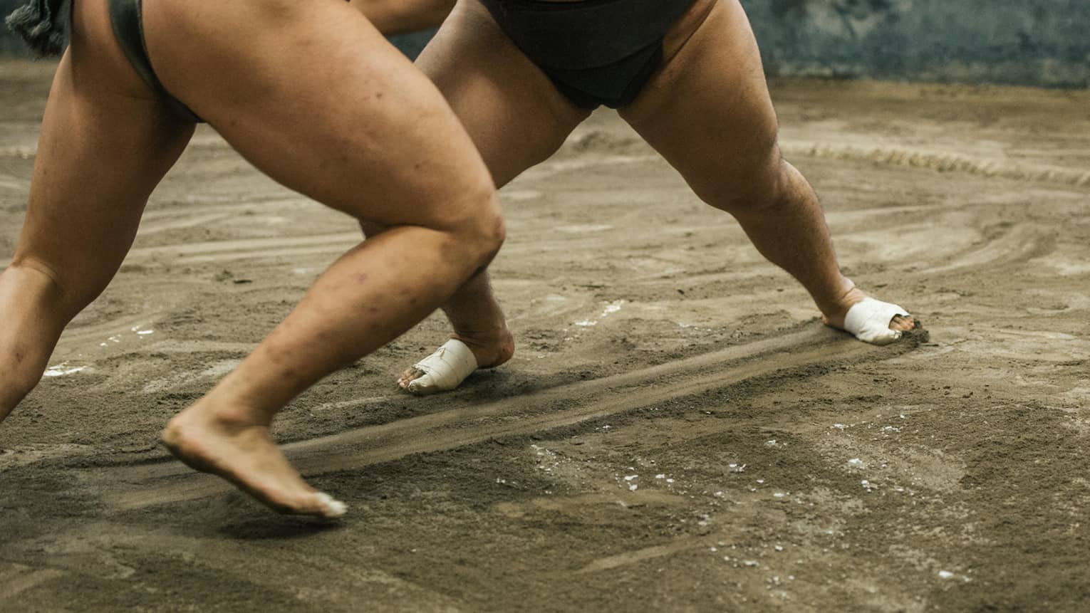Two sumo wrestlers participate in a match