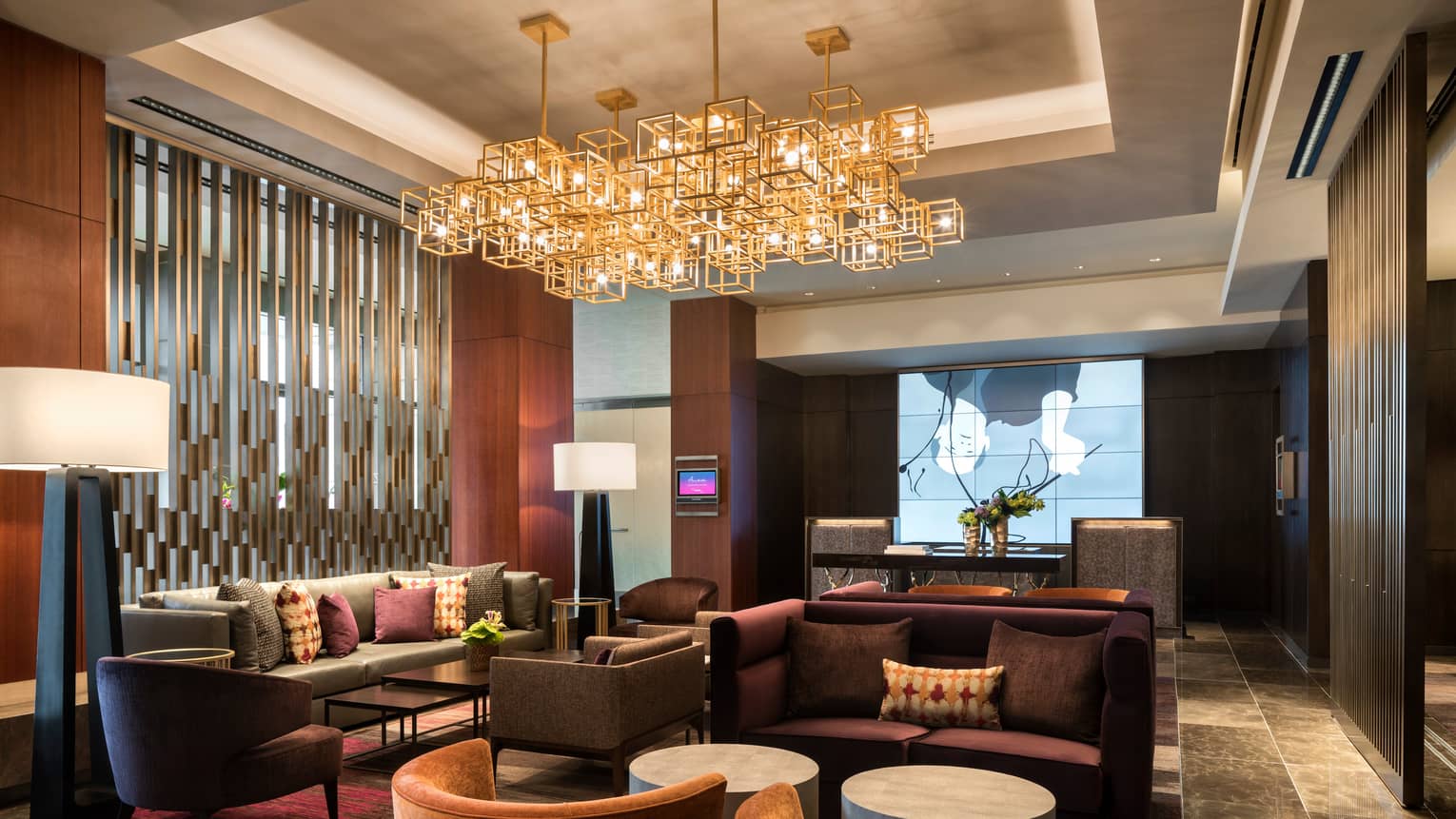 Armchairs, sofa in dimly lit Four Seasons Silicon Valley at East Palo Alto lobby