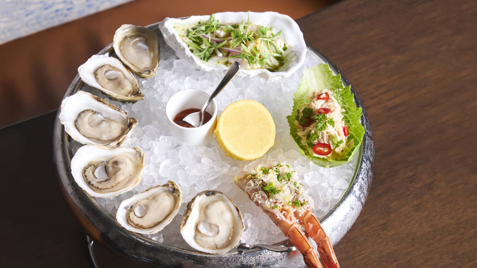 Oysters and lobster tail on ice.