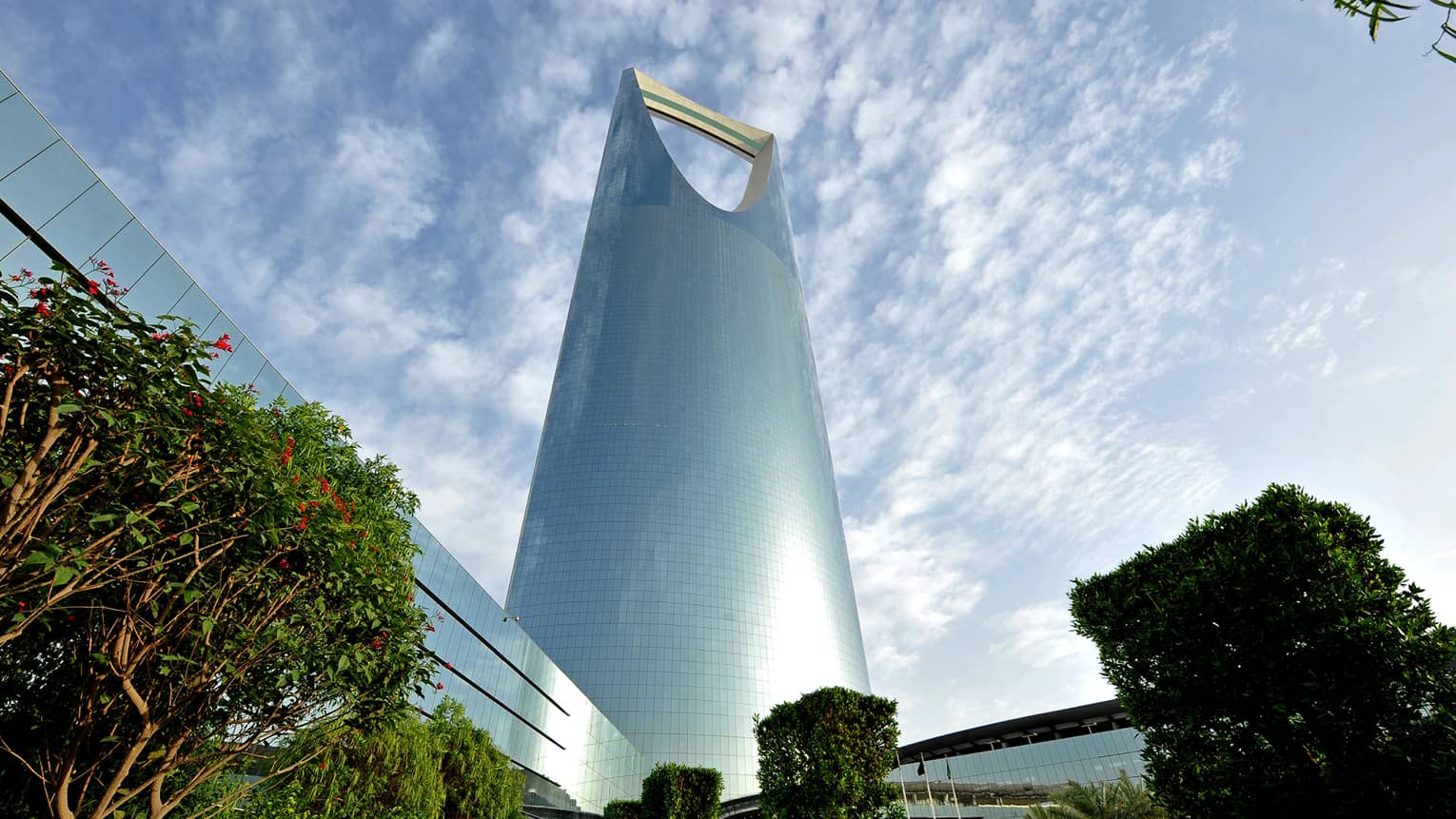 Looking up at soaring Four Seasons Hotel Riyadh at Kingdom Centre tower as sun reflects