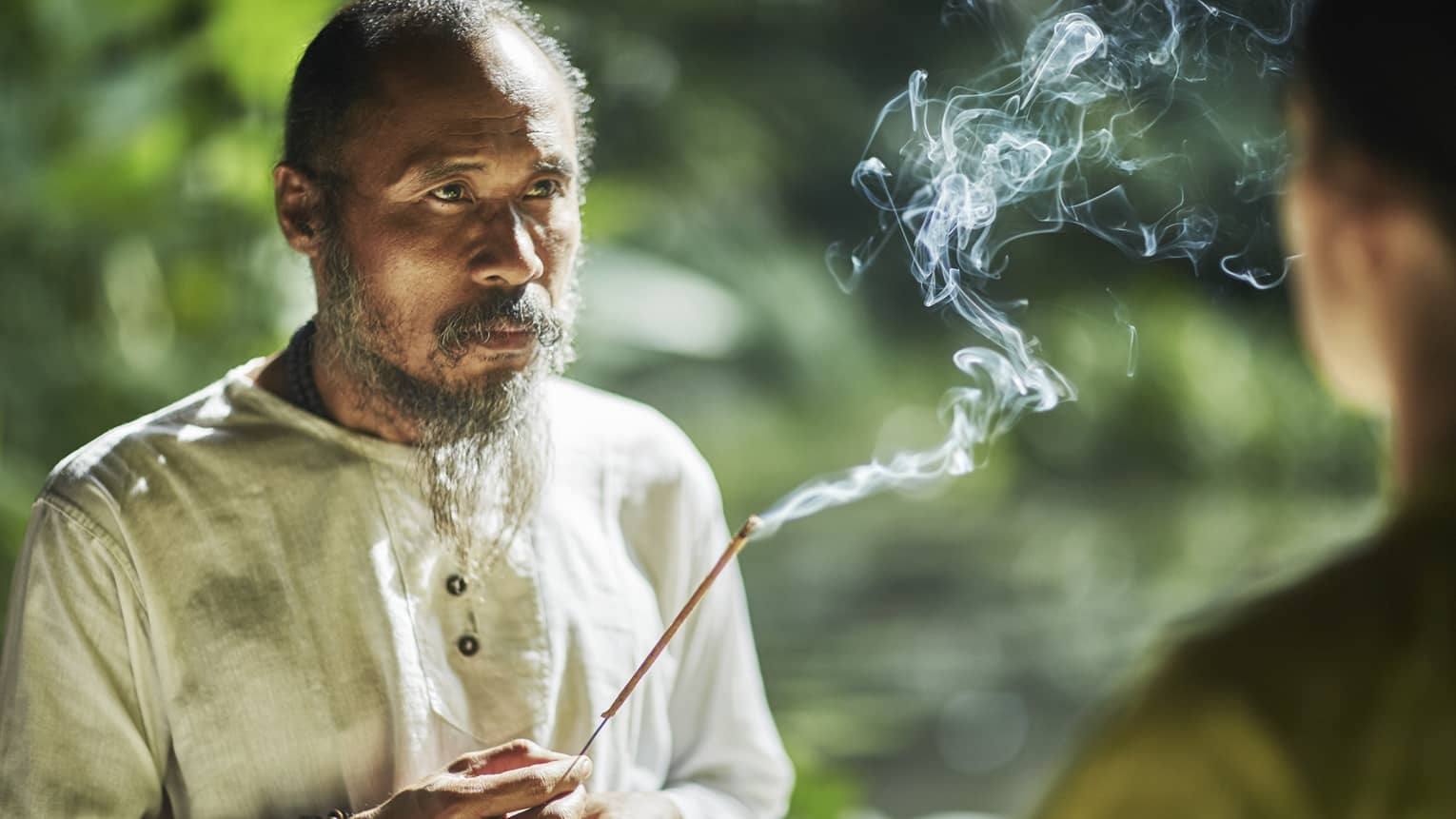 Balinese healer with burning incense