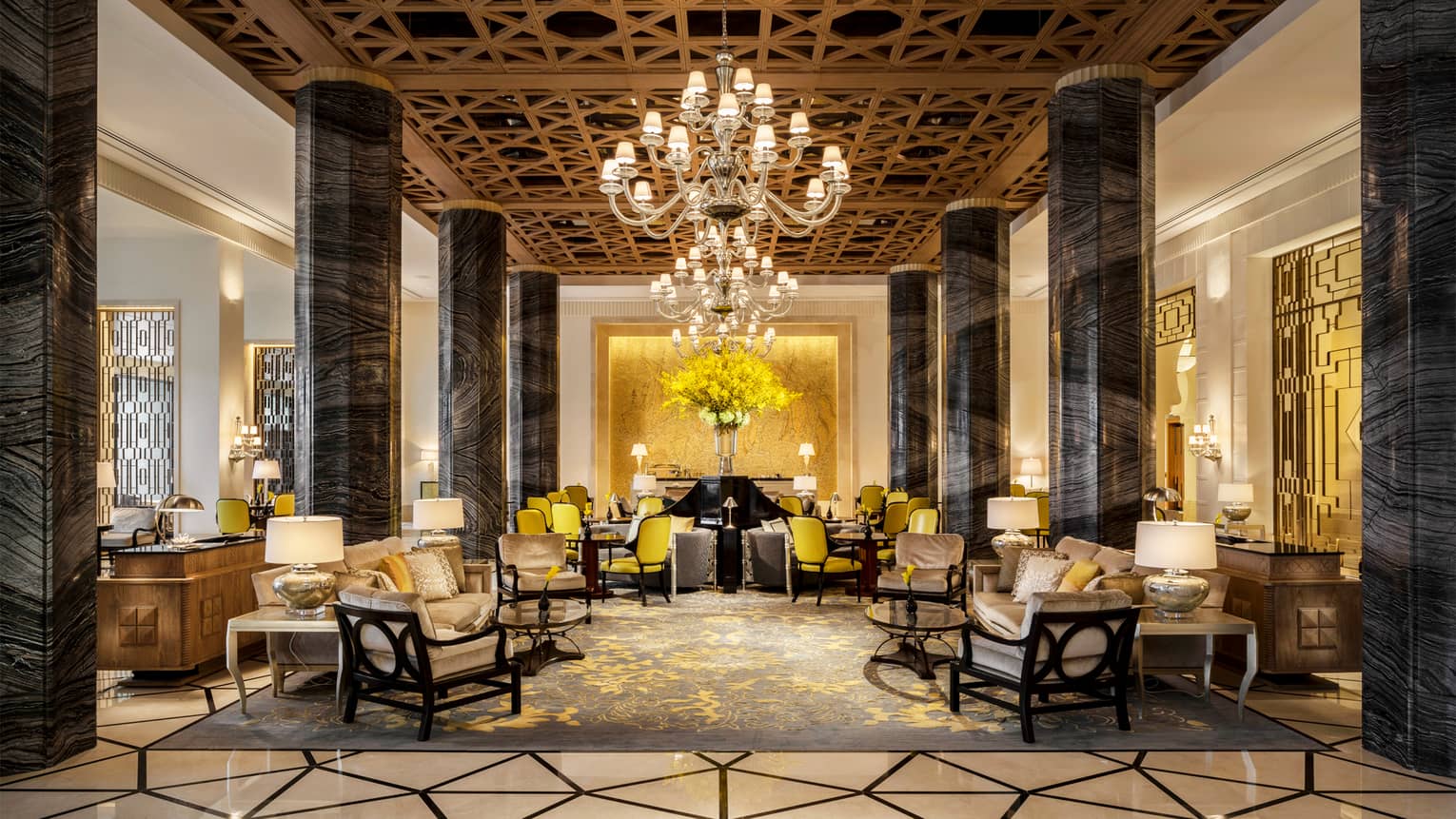 Shai Salon lobby with lattice ceilings, tall black marble pillars, two big chandeliers and numerous sofas
