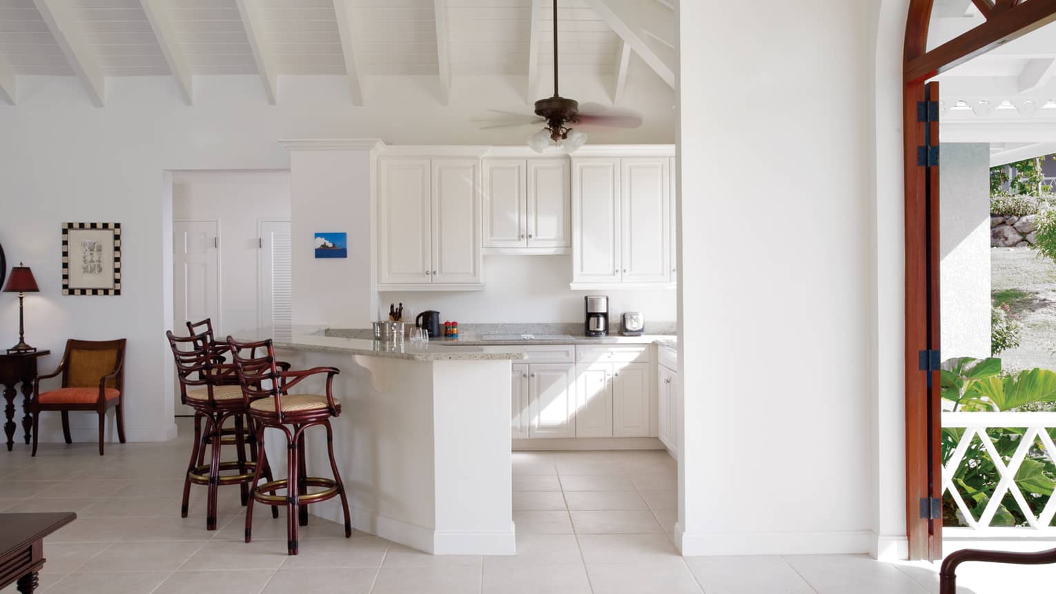 Sunset Hill Residence Villa white kitchen, wood stools at counter
