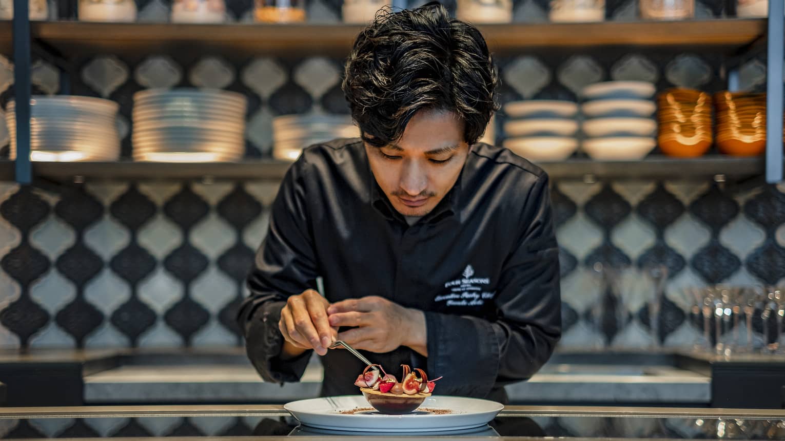 Pastry chef Yusuke Aoki puts the finishing touches on a dessert