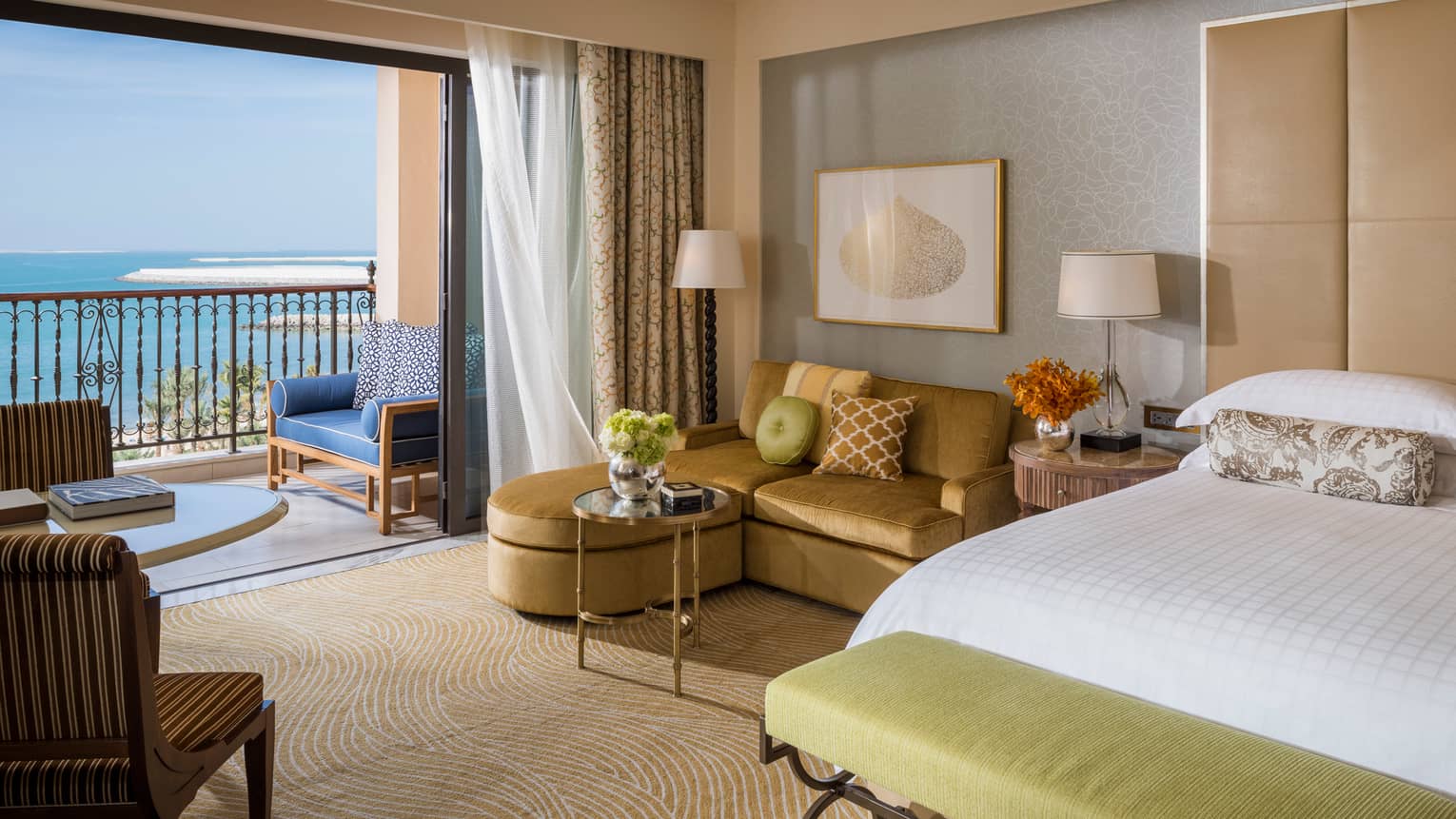 Premier Sea-View Room with L-shaped gold sofa beside oversized sliding glass door to balcony