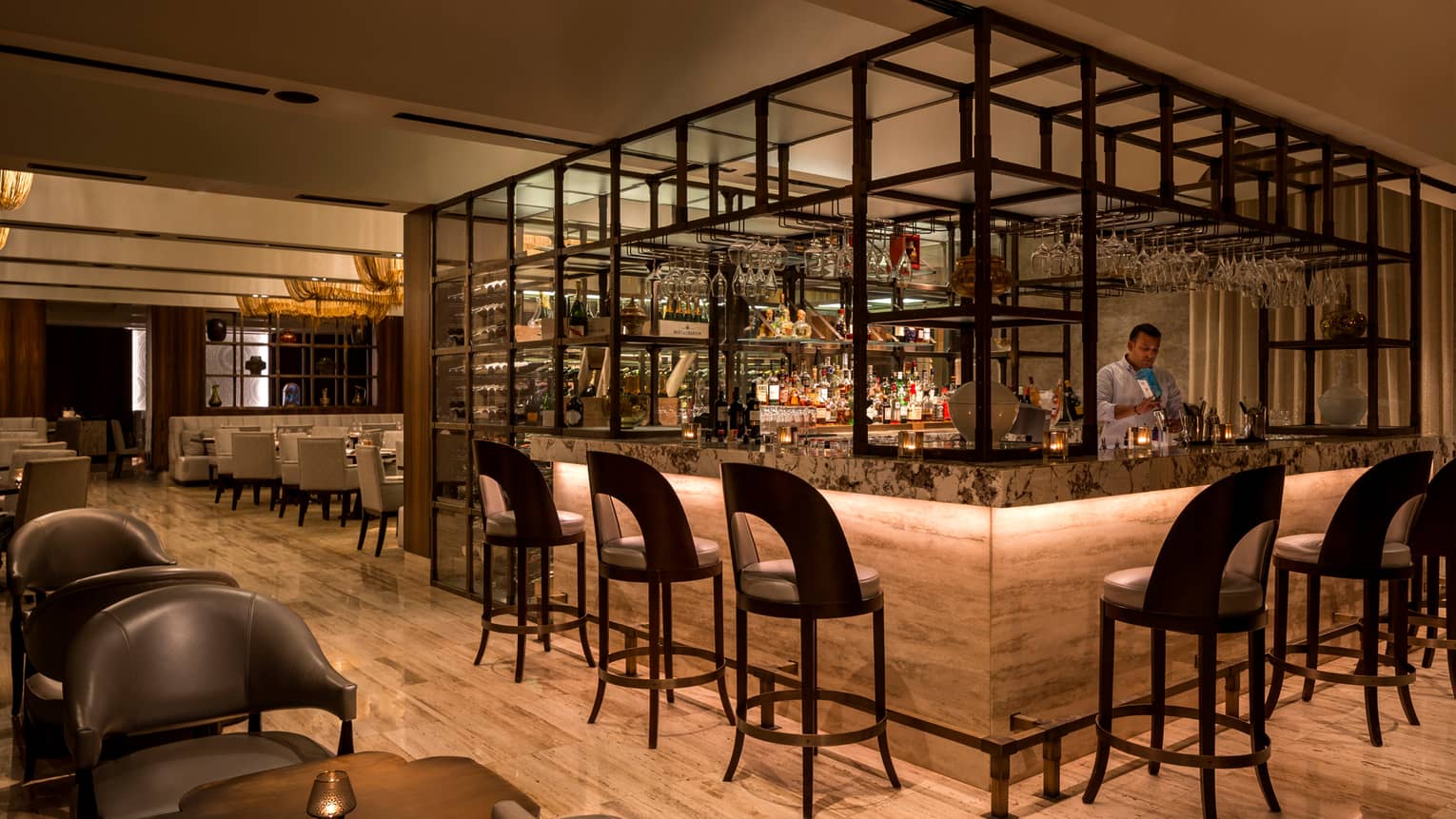 Modern framed bar with bartender, brown curved-back barstools and chairs, round tables, wood floor