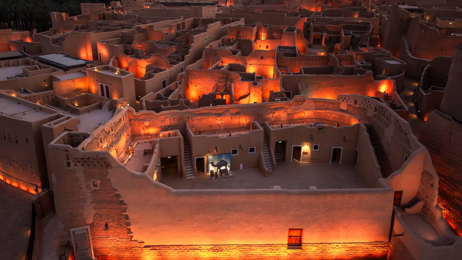 Overhead view of At-Turaif in Diriyah lit by lantern light