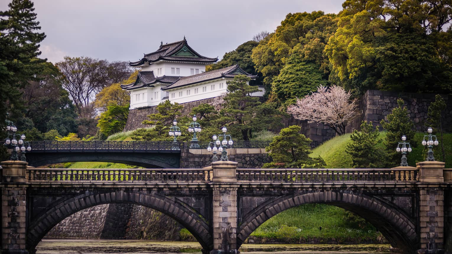 Historic brick bridge, Otemachi building tucked in hillside and trees