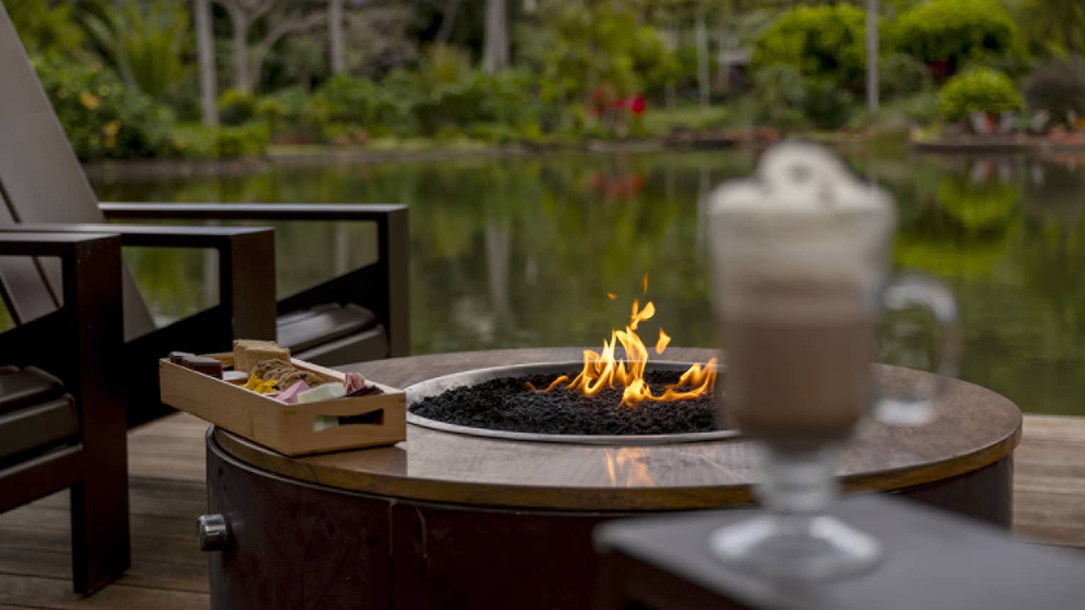 Outdoor, lakeside s'mores and hot chocolate on a deck