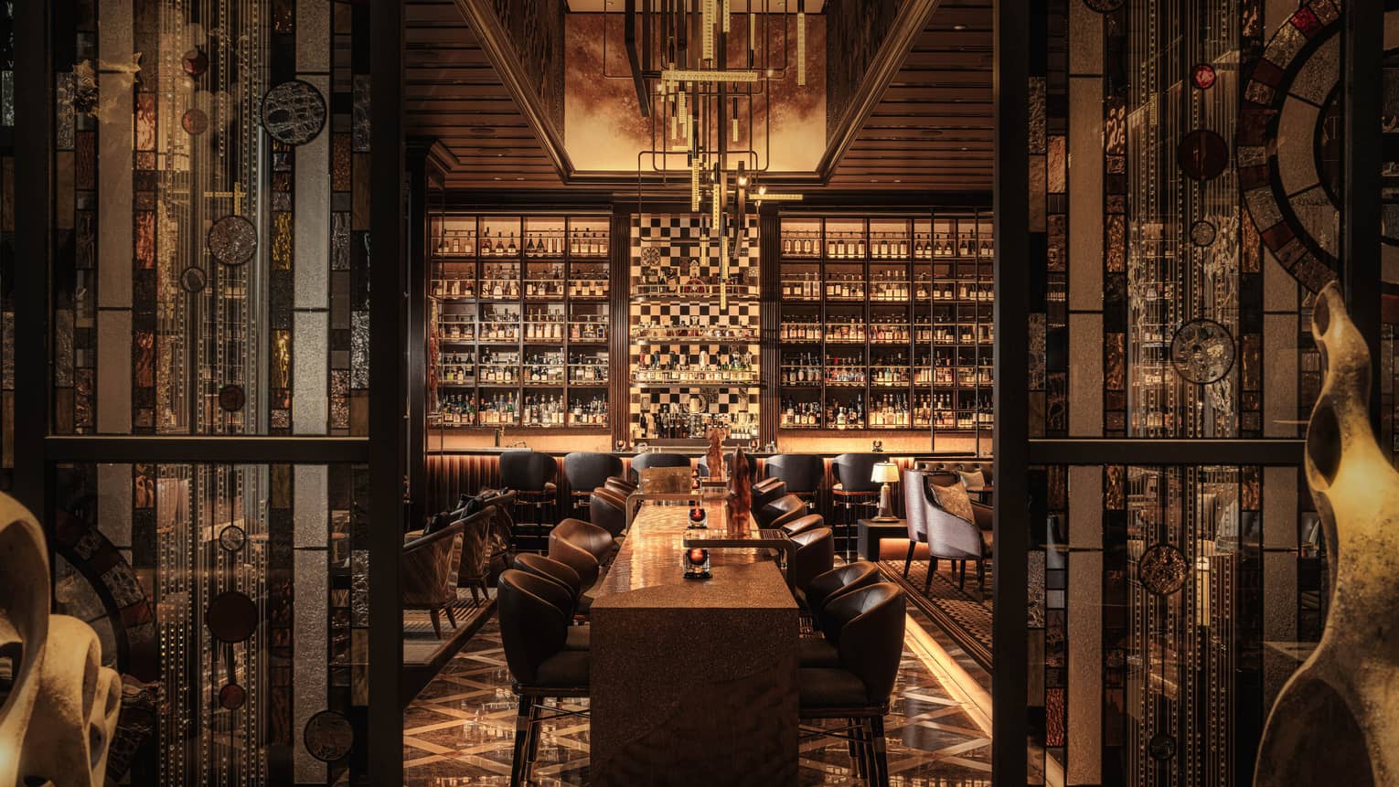 Moody bar with walls of beverage bottles and high-end leather seating