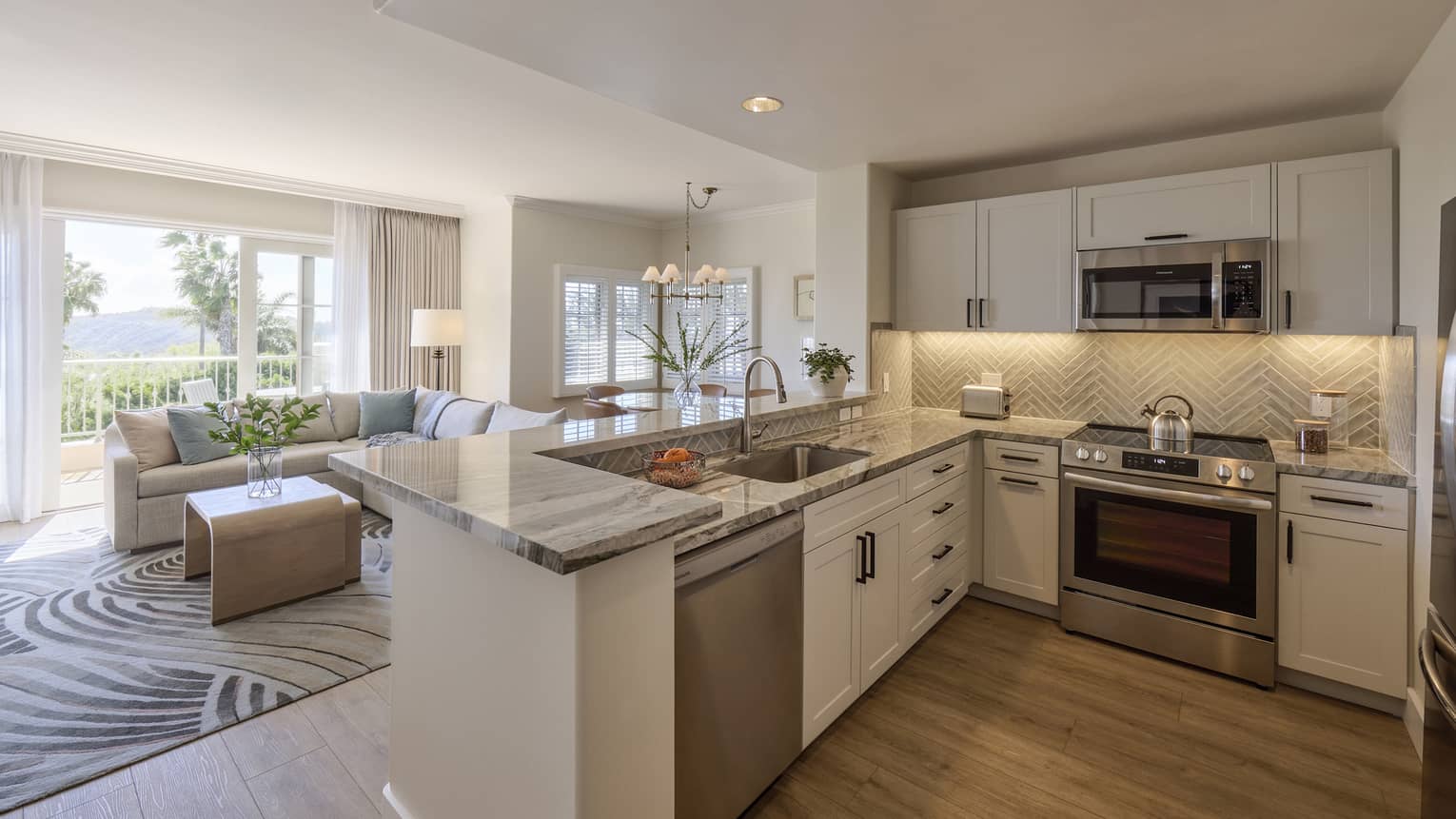 Villa kitchen with living room across the island, and a balcony