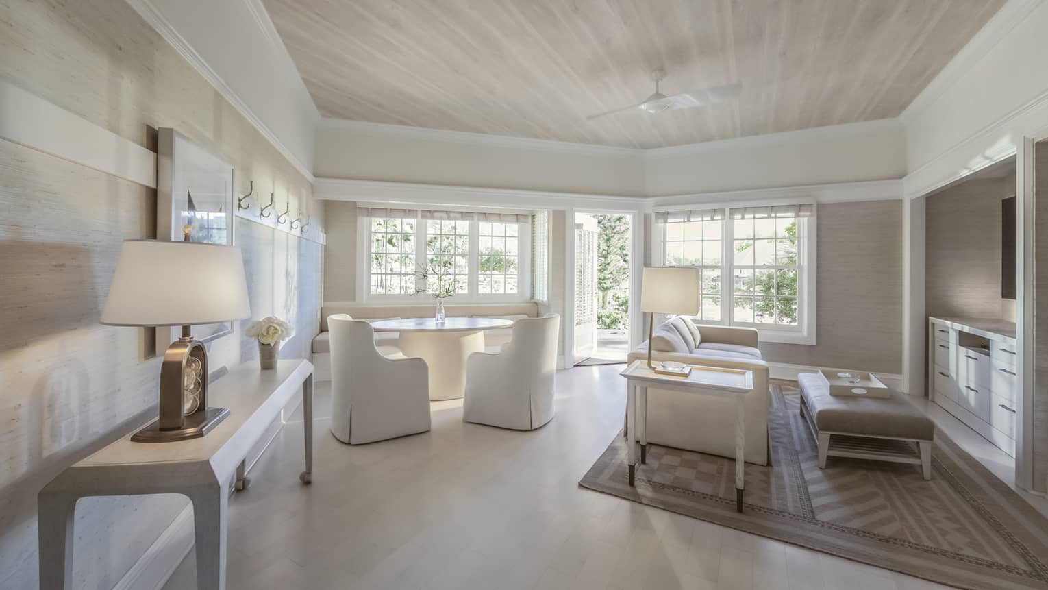 Guest room with white couches and dining table