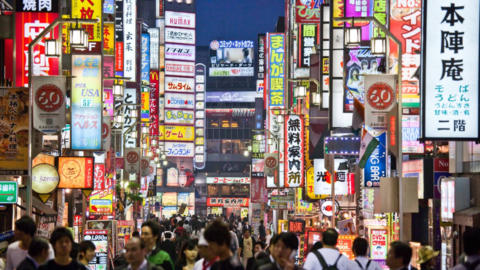 Crowds under Tokyo lights, colourful billboards