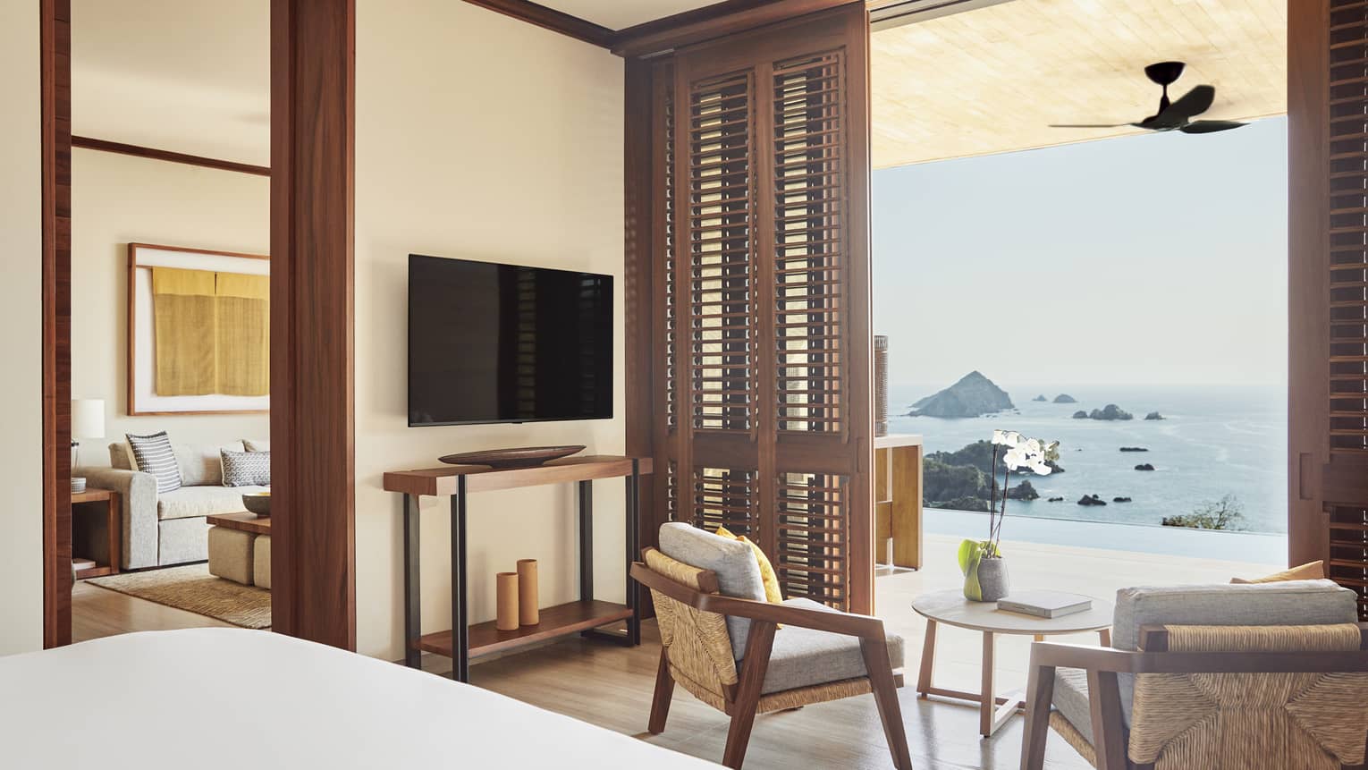 Resort bedroom opening to a private infinity pool terrace with a Tamarindo ocean view