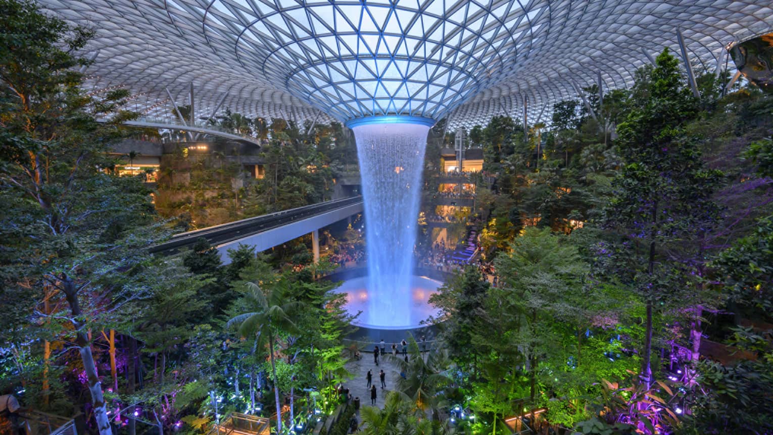 An arial view of an indoor garden with a large fountain in the center in singapore