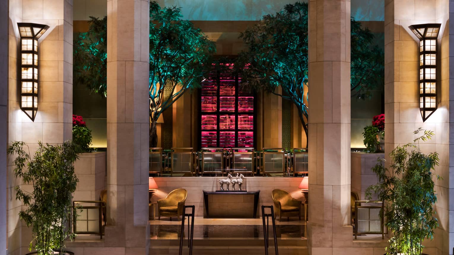 Lanterns on stone pillars, stairs leading up to The Garden bar and lounge
