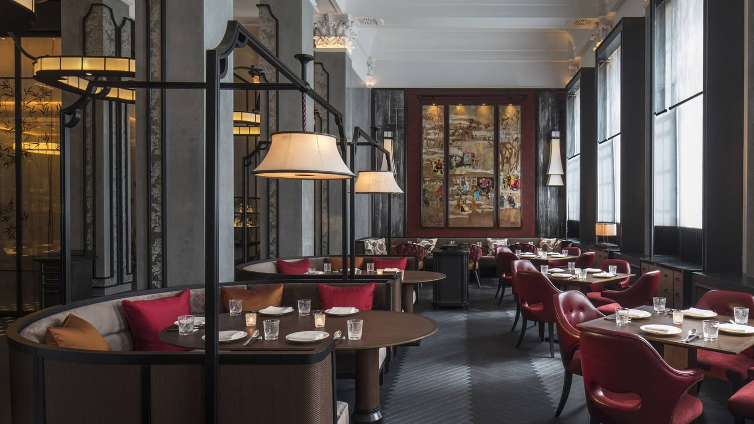 Wide view of Mei Ume dining room with brown tables, red chairs and red and brown accent pillows
