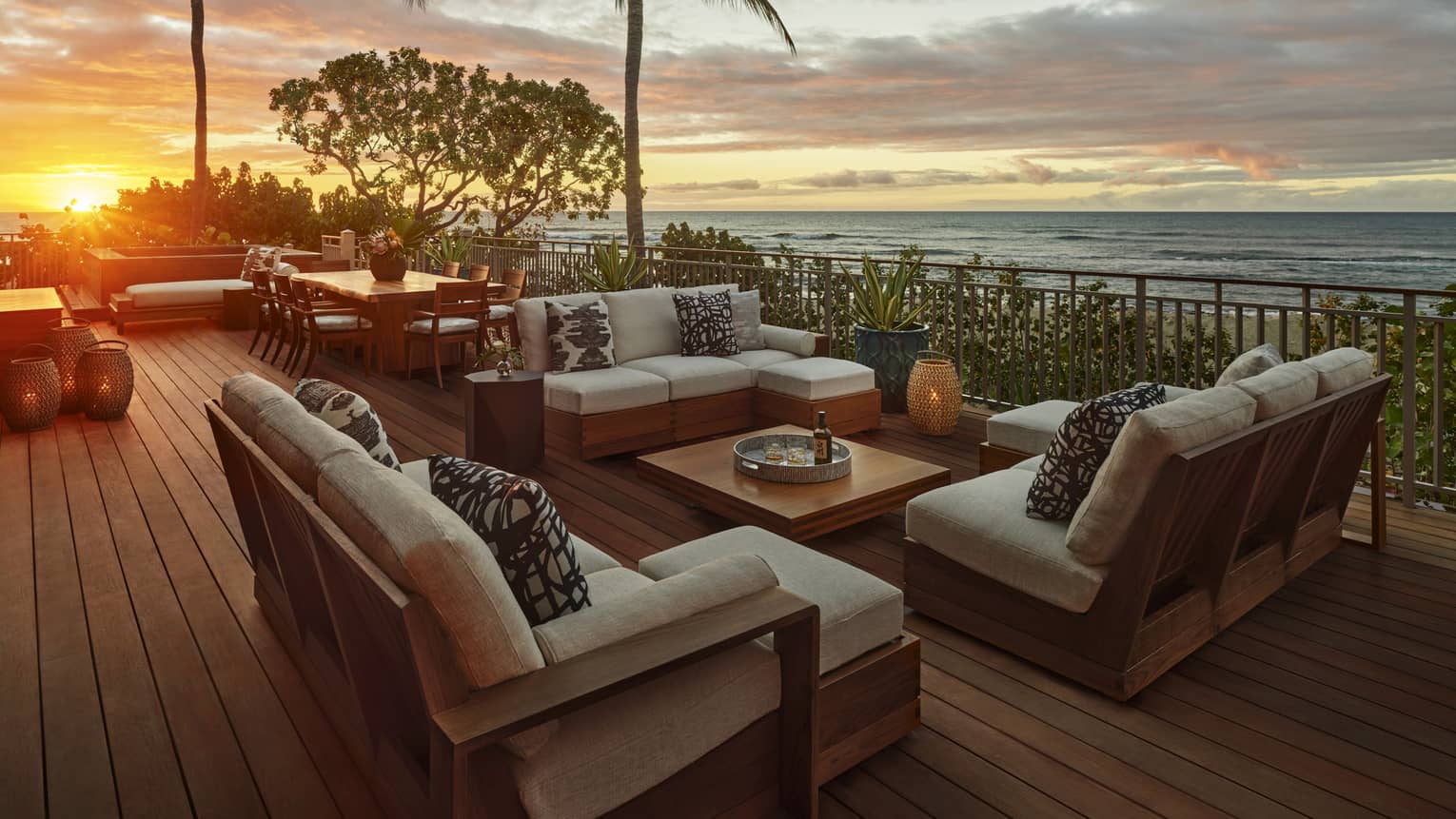Outdoor deck with lounge furniture at sunset with ocean view