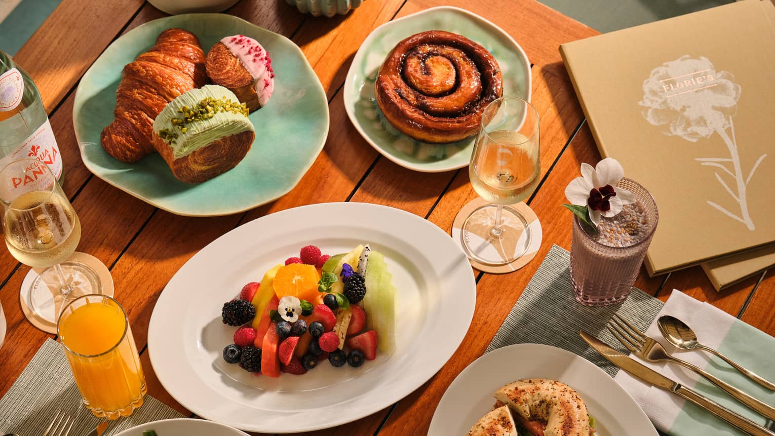 Outdoor table filled with a variety of breakfast dishes