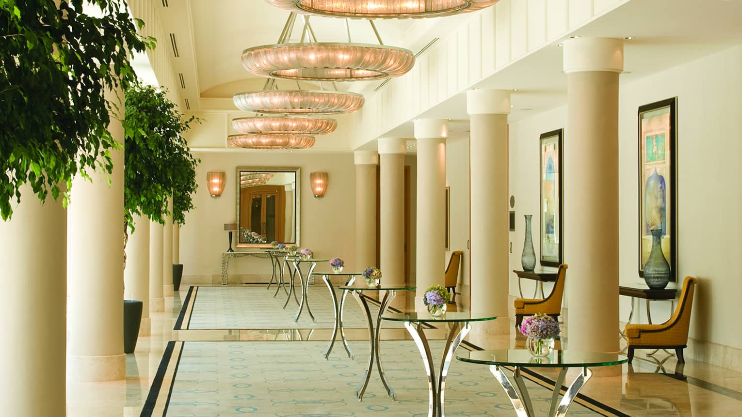 White pillars, glass cocktail tables in bright Atik Pasha ballroom pre-function area 