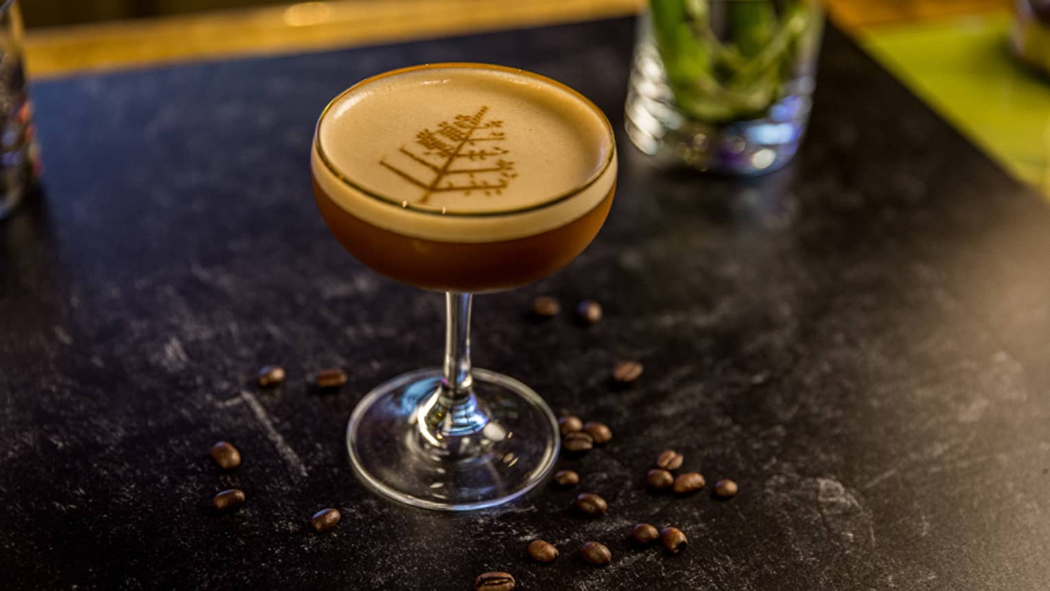 A cocktail with a Four Seasons symbol as garnish.