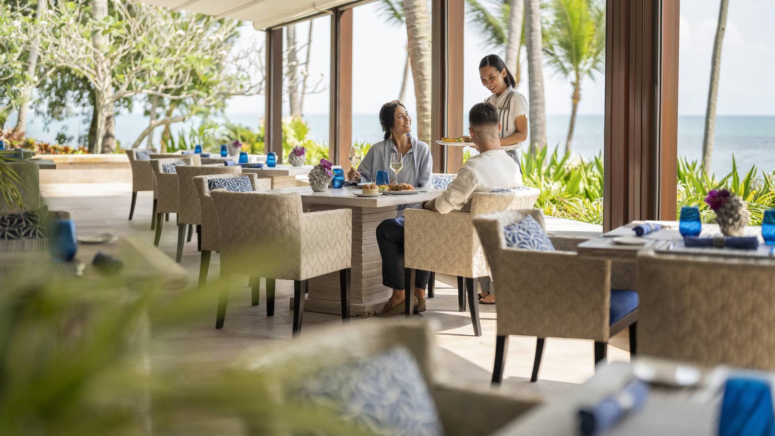 Smiling female waitress takes couple?s order at Pla Pla