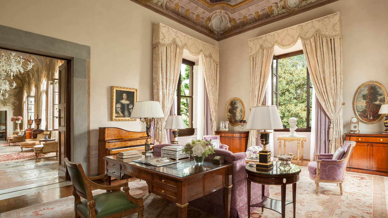 Royal Suite large wood work desk, pink silk sofa and chairs, tall windows under vaulted ceilings