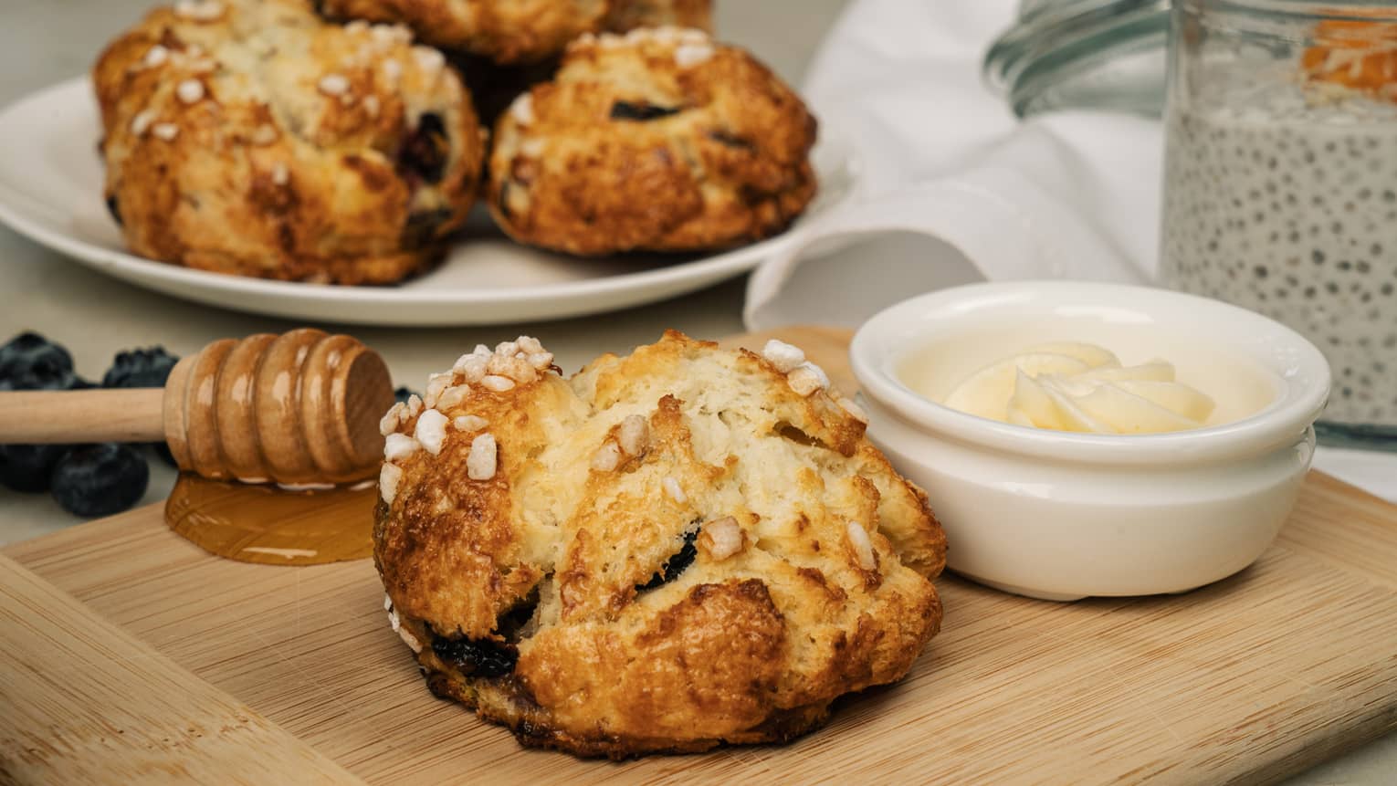 Small boule of bread with dish of butter and honey