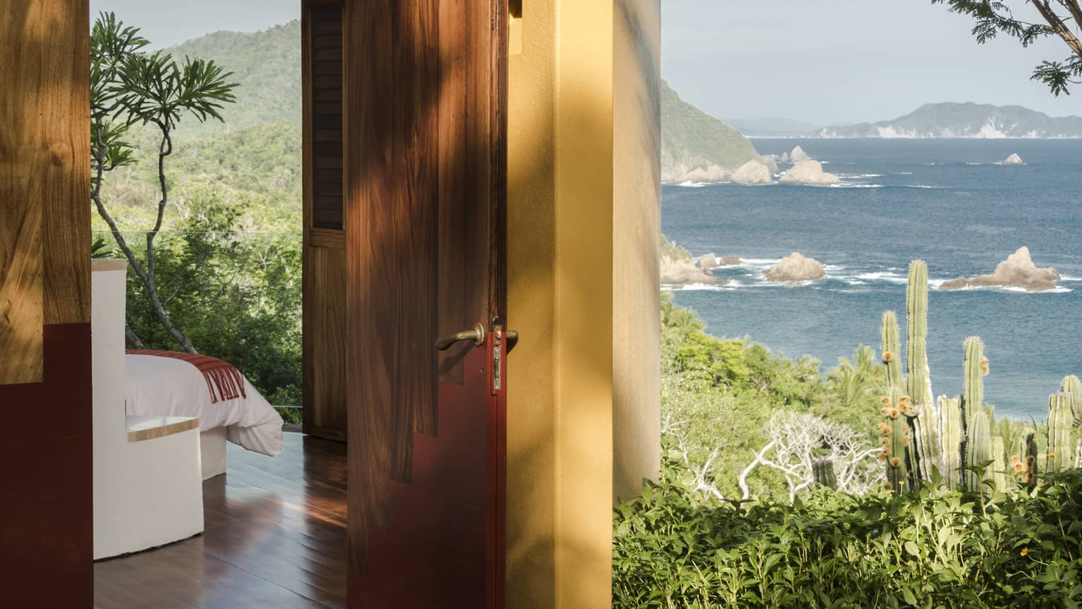 Bedroom opening to outdoor terrace with ocean view
