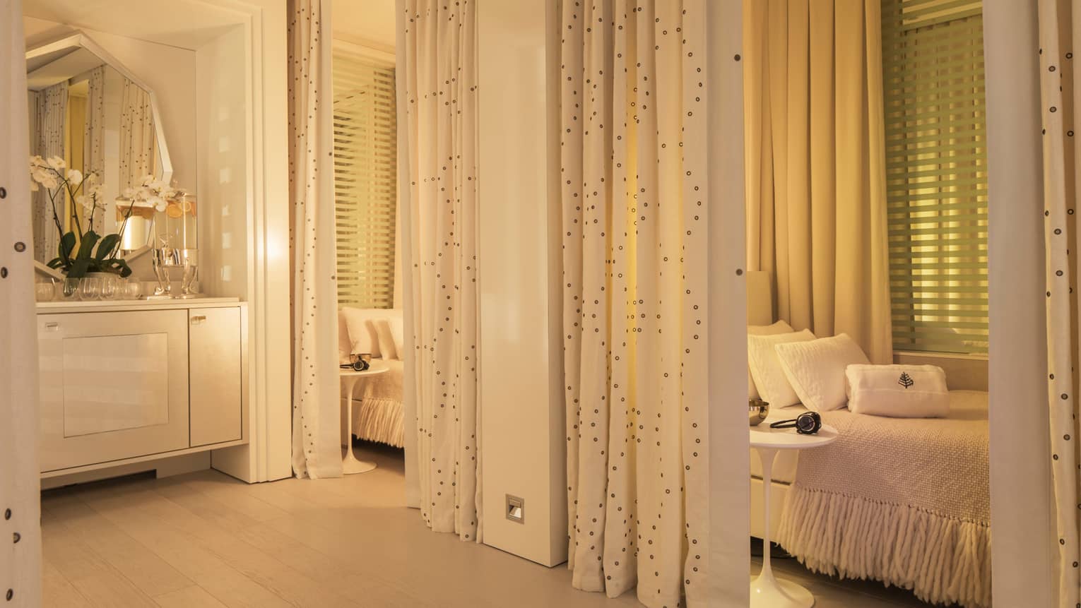 Spa relaxation alcoves with beds, pillows, headsets behind curtains