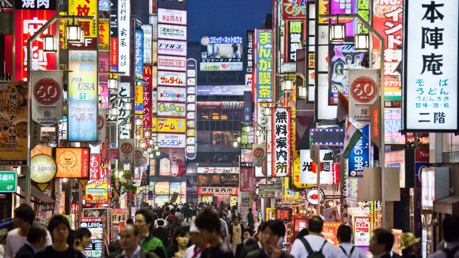 Crowds under Tokyo lights, colourful billboards