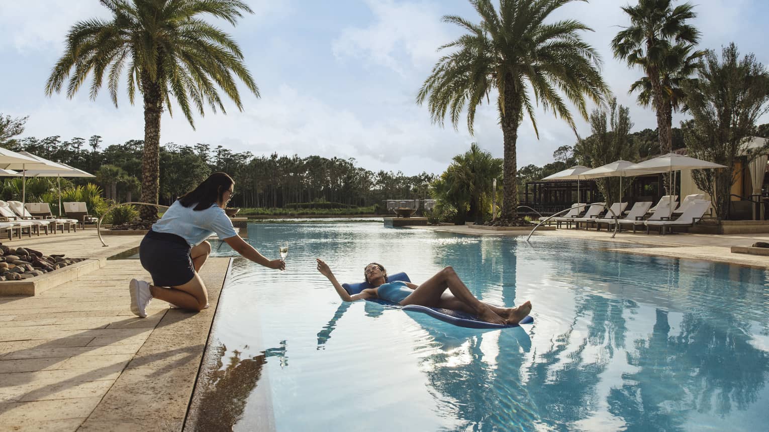 Woman enjoying a beverage in the pool