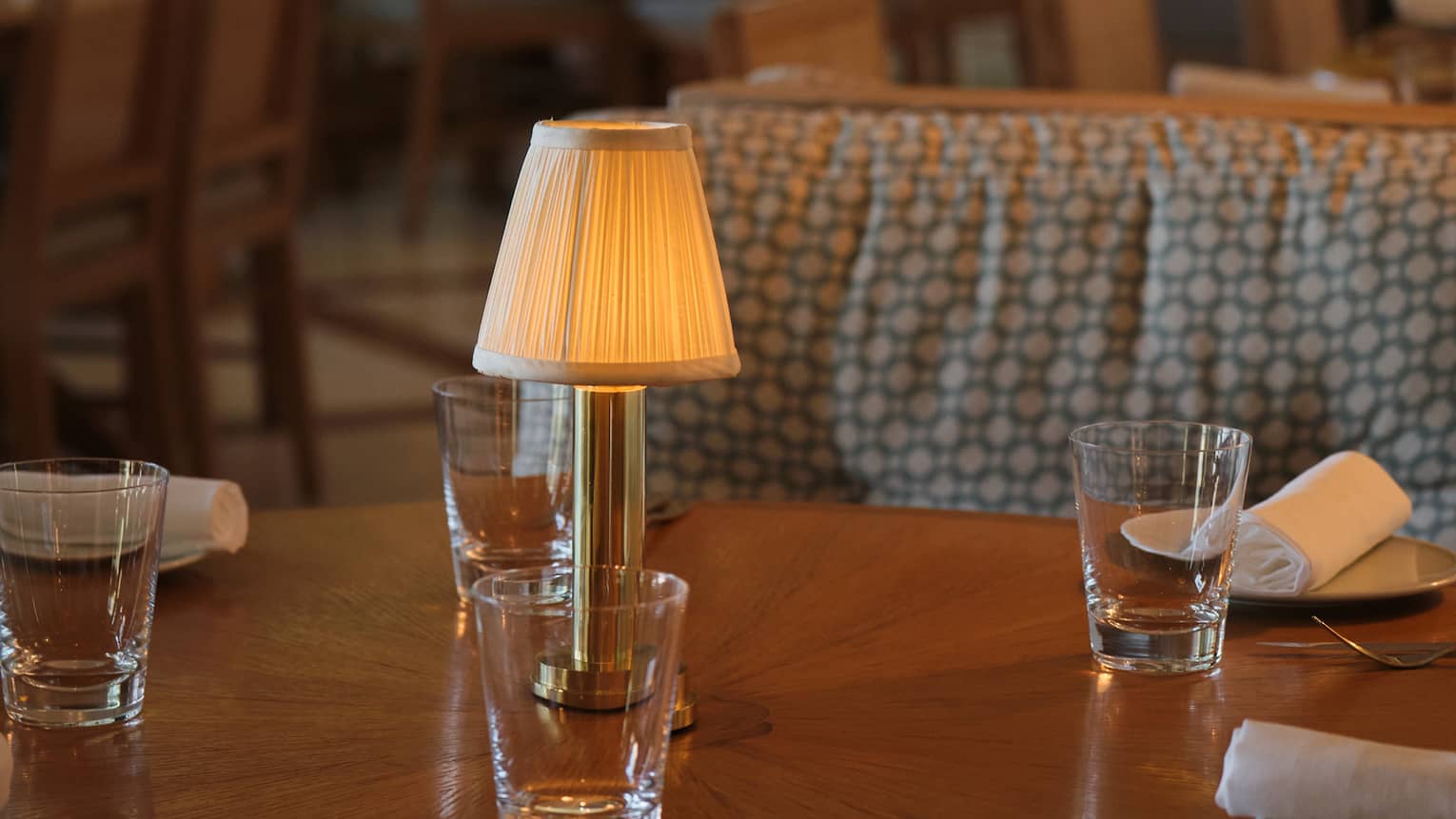 Restaurant dining table topped with a minature lamp