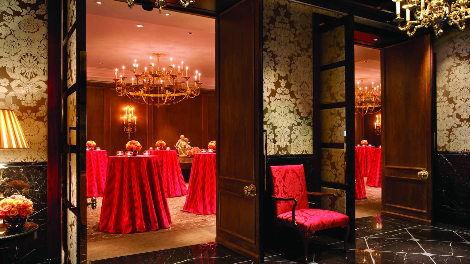 Oak Room event space with elegant red silk chairs, cocktail table linens