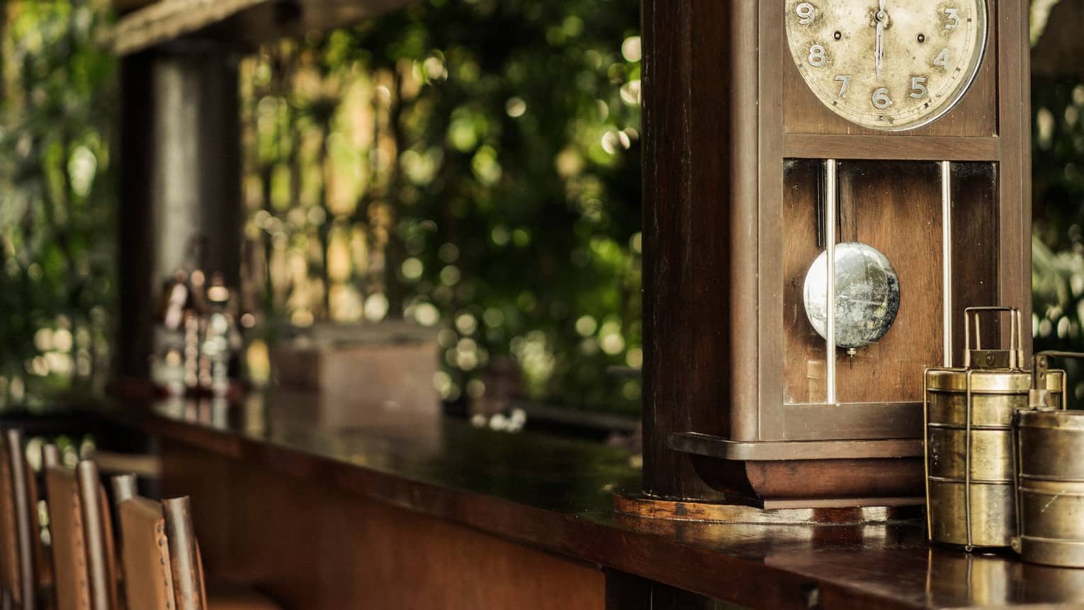 Nong Yao restaurant, close-up of antique clock on wood bar, chair 